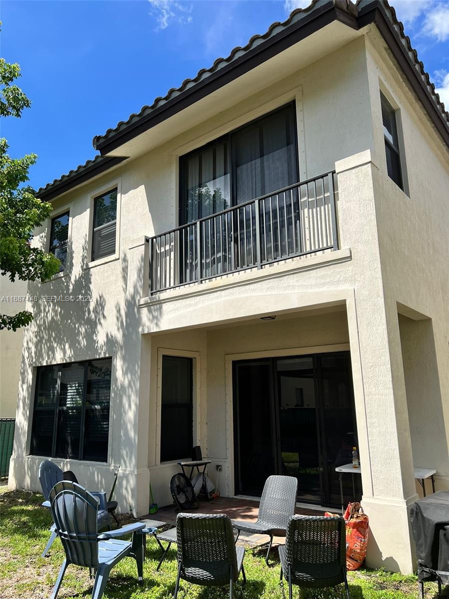 3214 West 97th Street Hialeah, FL 33018 - Photo 4 of 22 a view of a house with a chairs in patio