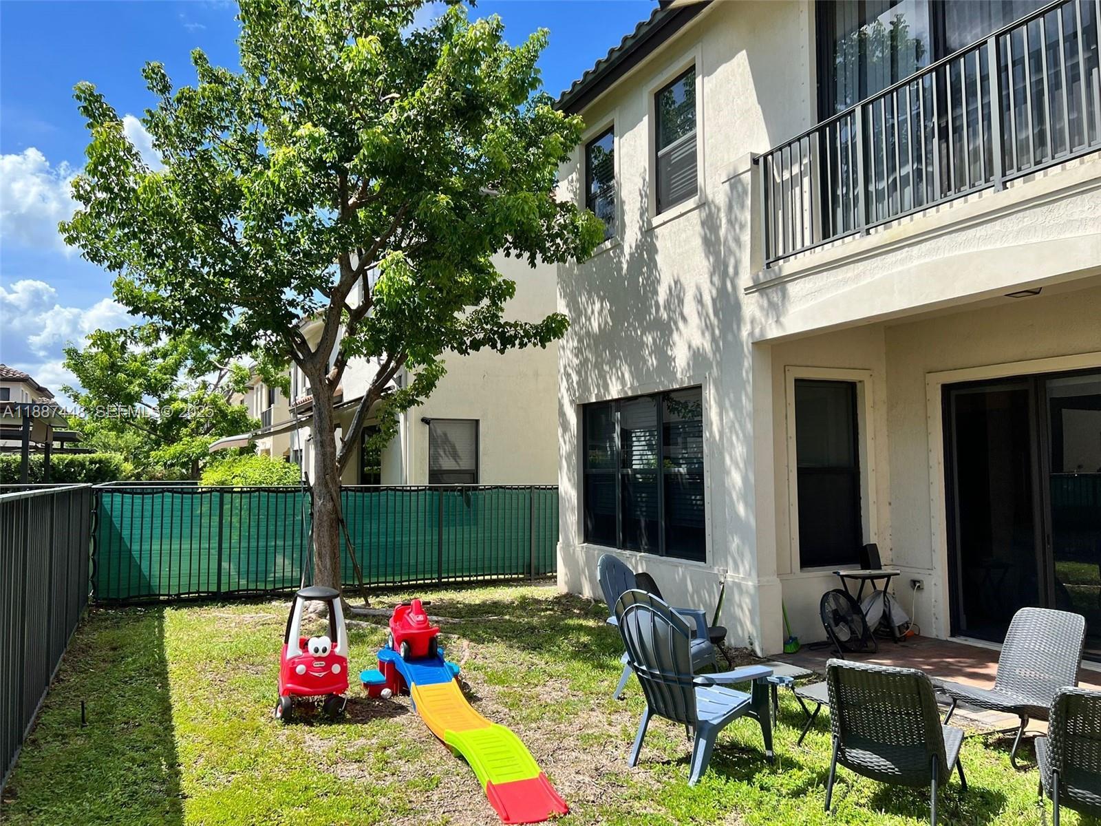3214 West 97th Street Hialeah, FL 33018 - Photo 5 of 22 a backyard of a house with seating space