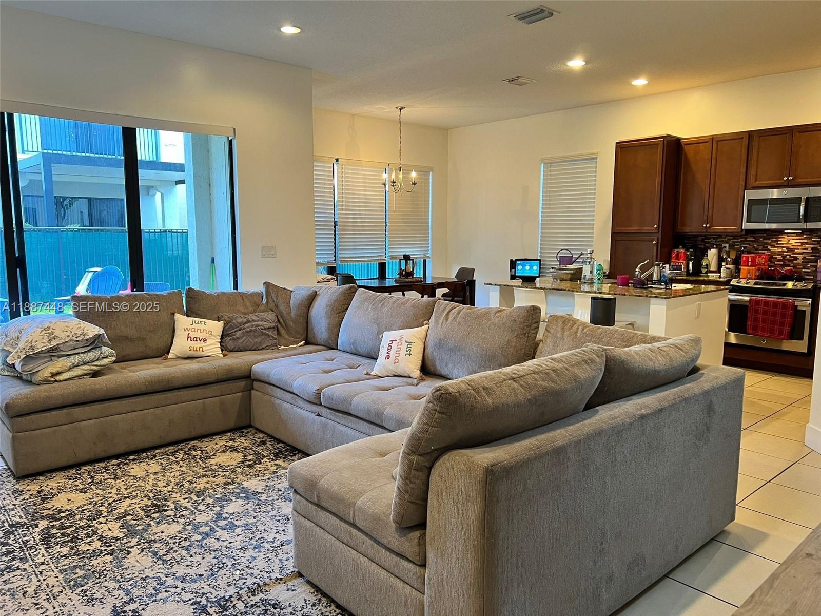3214 West 97th Street Hialeah, FL 33018 - Photo 10 of 22 a living room with furniture and a flat screen tv