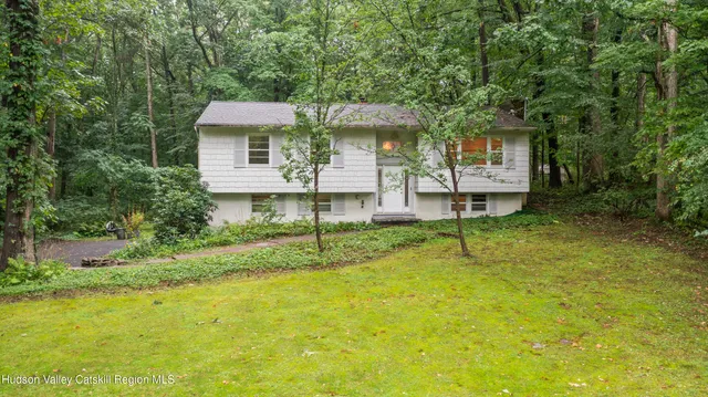 a front view of a house with a yard table and chairs
