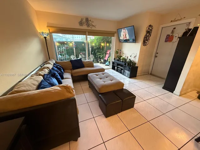 a living room with furniture and a floor to ceiling window