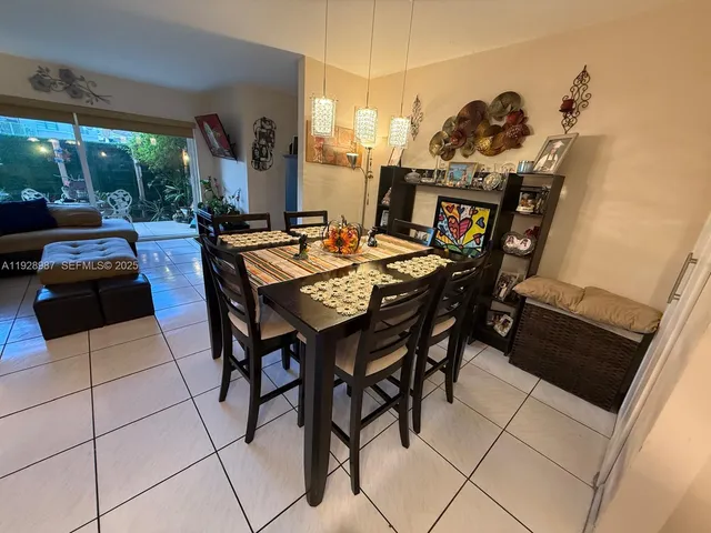 a view of a dining room with furniture and a chandelier