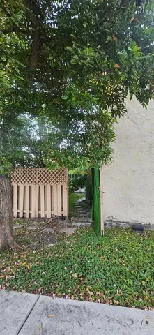 a view of building with yard and ocean view