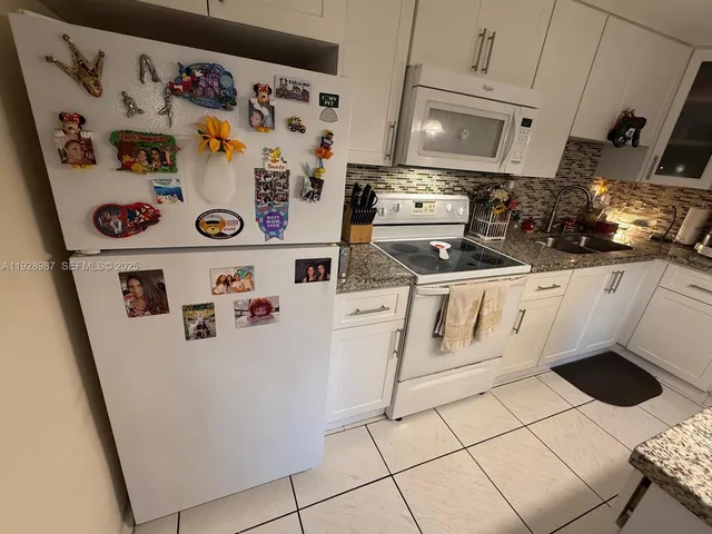 a kitchen with a sink stove and microwave