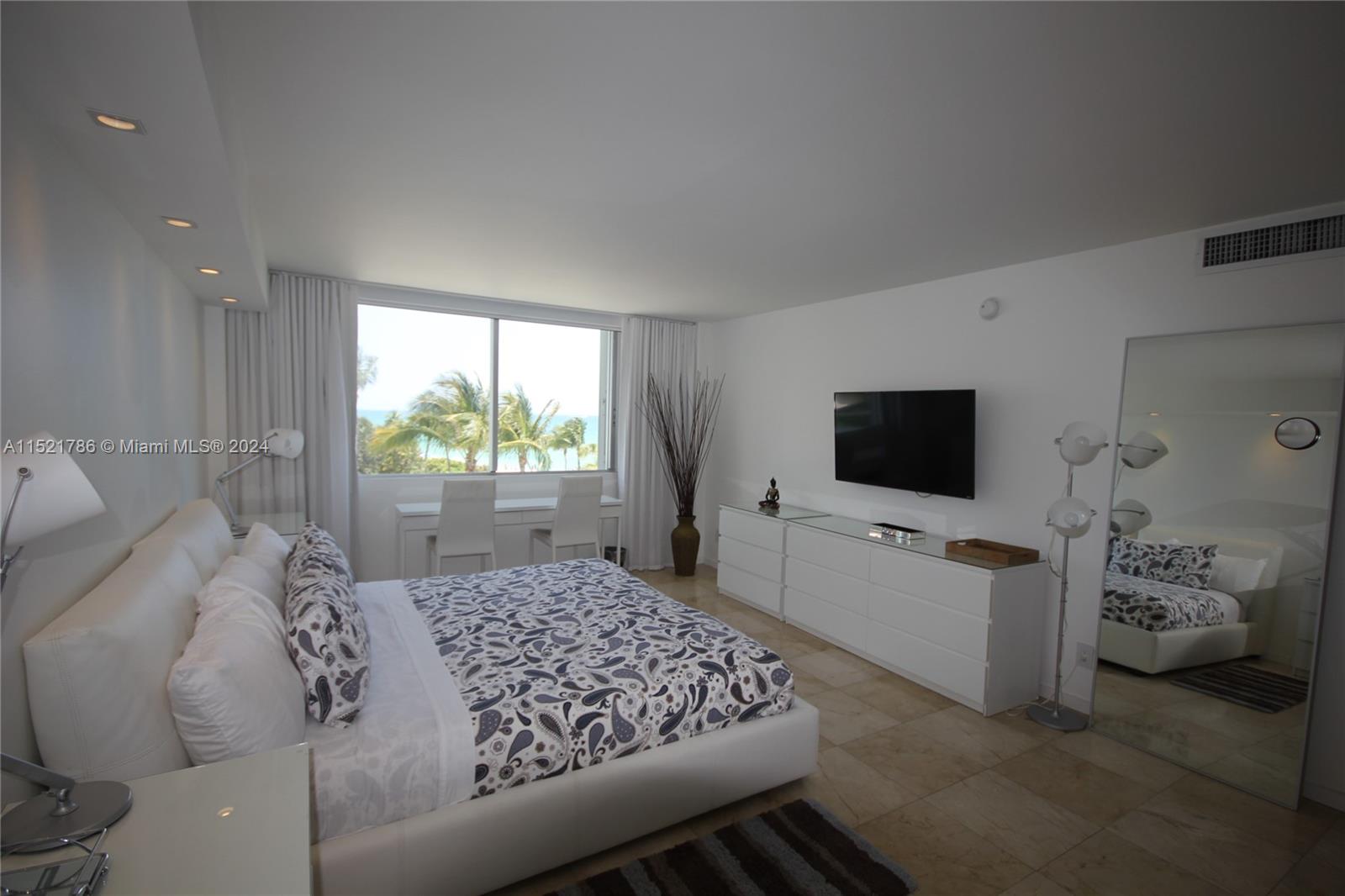 5151 Collins Avenue, Unit 532 Miami Beach, FL 33140 - Photo 16 of 62 a bedroom with a bed and a flat screen tv