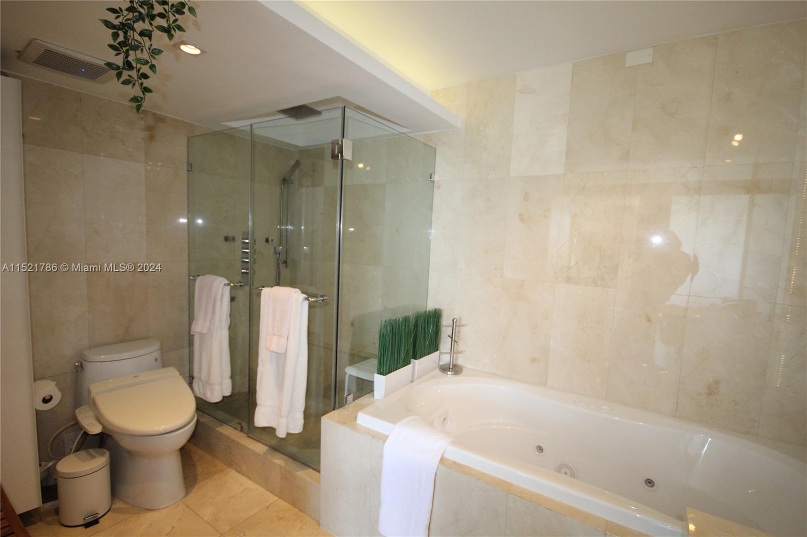 5151 Collins Avenue, Unit 532 Miami Beach, FL 33140 - Photo 19 of 62 a bathroom with a toilet and a bathtub