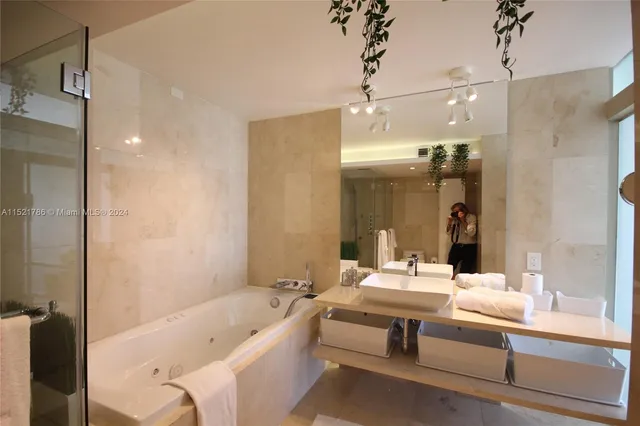 a bedroom with two beds and a flat screen tv