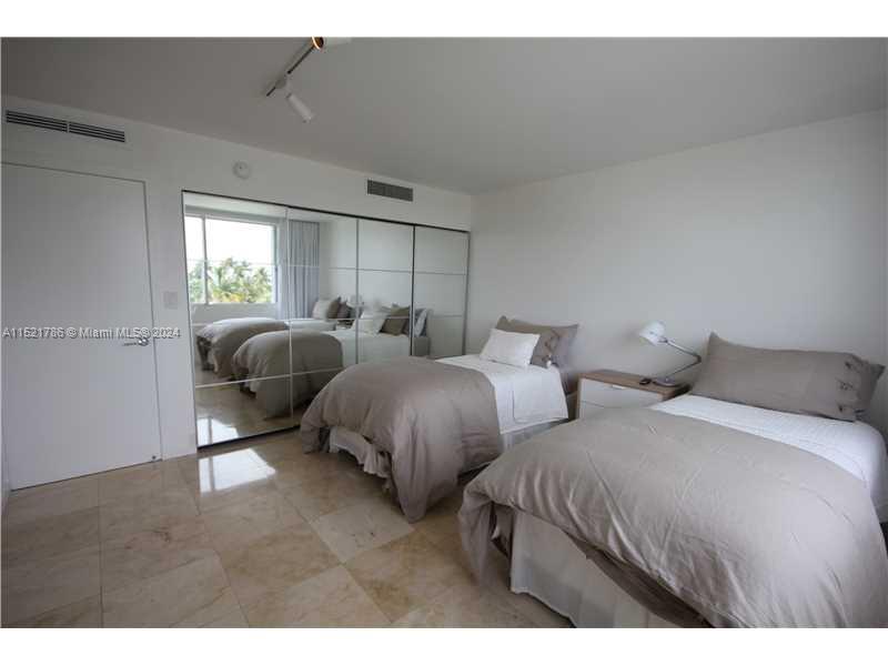 5151 Collins Avenue, Unit 532 Miami Beach, FL 33140 - Photo 25 of 62 a bedroom with two beds and a dresser
