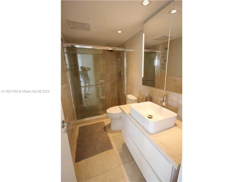5151 Collins Avenue, Unit 532 Miami Beach, FL 33140 - Photo 28 of 62 a bathroom with a sink a toilet and shower