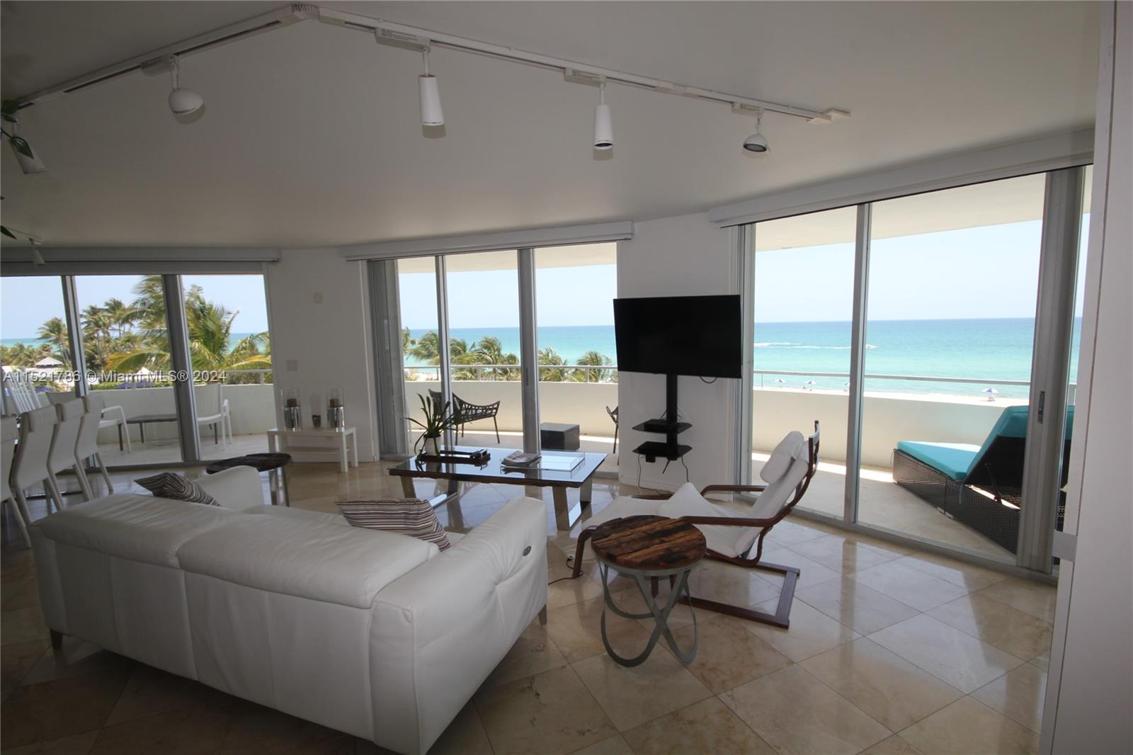 5151 Collins Avenue, Unit 532 Miami Beach, FL 33140 - Photo 58 of 62 a living room with furniture and large windows