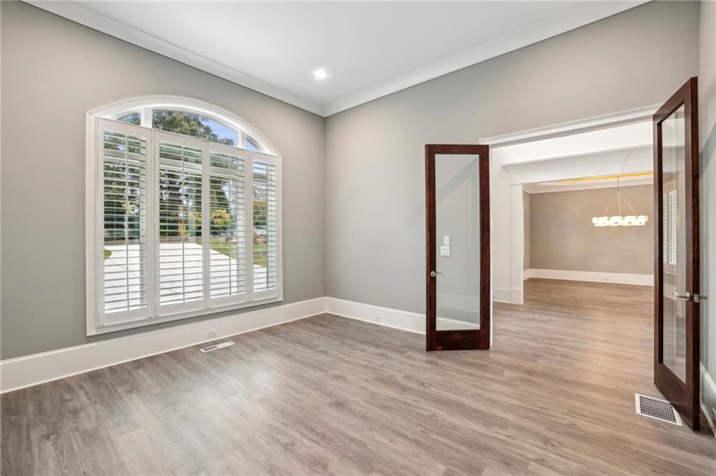 3750 Robinson Road Northeast Marietta, GA 30068 - Photo 11 of 57 a view of an empty room with wooden floor and a window