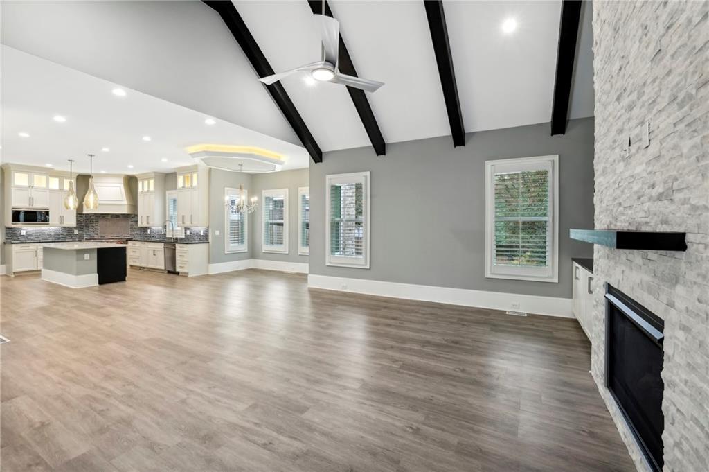 3750 Robinson Road Northeast Marietta, GA 30068 - Photo 18 of 57 a view of an empty room with wooden floor and a kitchen