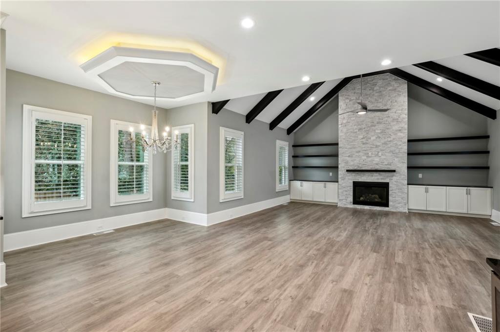 3750 Robinson Road Northeast Marietta, GA 30068 - Photo 19 of 57 an empty room with wooden floor fireplace and windows