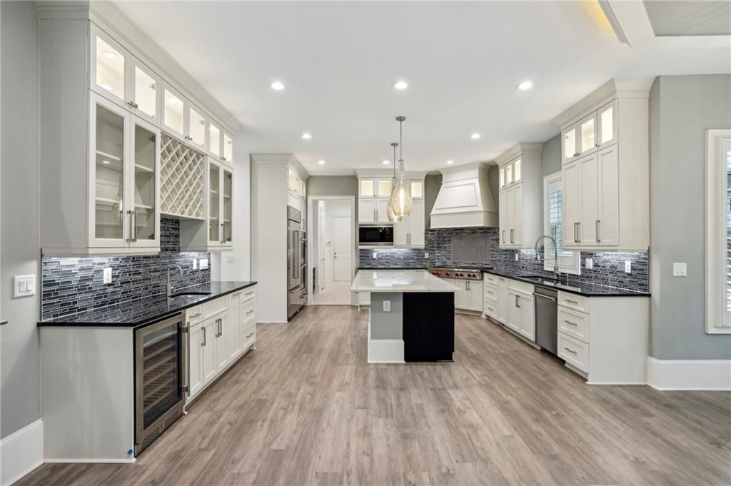 3750 Robinson Road Northeast Marietta, GA 30068 - Photo 21 of 57 a large kitchen with granite countertop a large counter top space a sink stainless steel appliances and cabinets