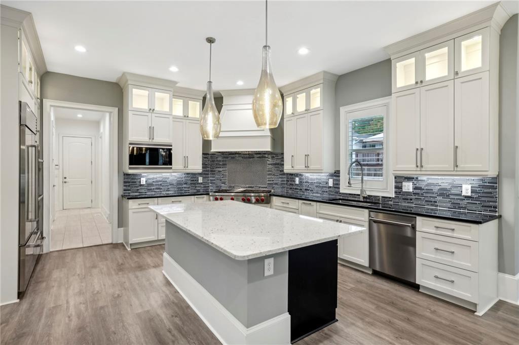 3750 Robinson Road Northeast Marietta, GA 30068 - Photo 22 of 57 a large kitchen with granite countertop a sink a counter space appliances and cabinets