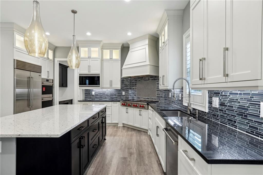 3750 Robinson Road Northeast Marietta, GA 30068 - Photo 23 of 57 a kitchen with stainless steel appliances granite countertop a sink a stove and a refrigerator