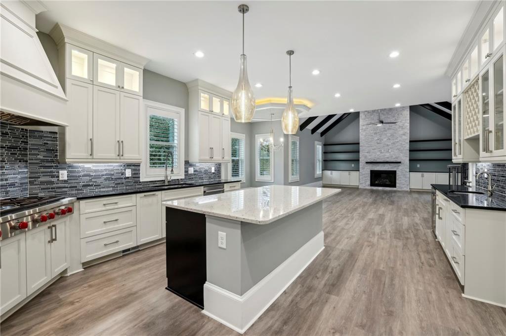 3750 Robinson Road Northeast Marietta, GA 30068 - Photo 25 of 57 a large kitchen with stainless steel appliances kitchen island granite countertop a large counter top a stove a sink and a wooden floors