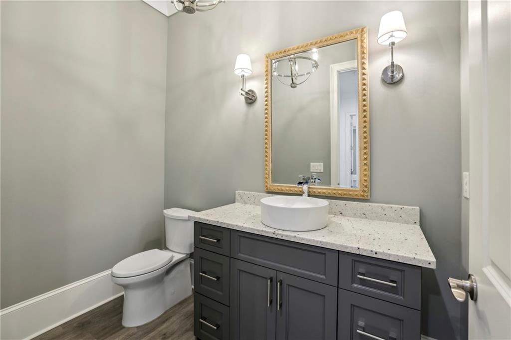 3750 Robinson Road Northeast Marietta, GA 30068 - Photo 30 of 57 a bathroom with a granite countertop sink a toilet and a mirror