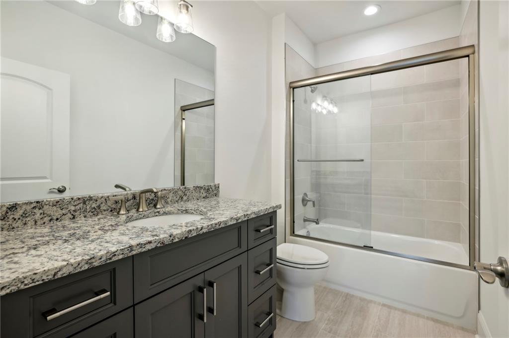 3750 Robinson Road Northeast Marietta, GA 30068 - Photo 43 of 57 a bathroom with a granite countertop sink toilet and shower