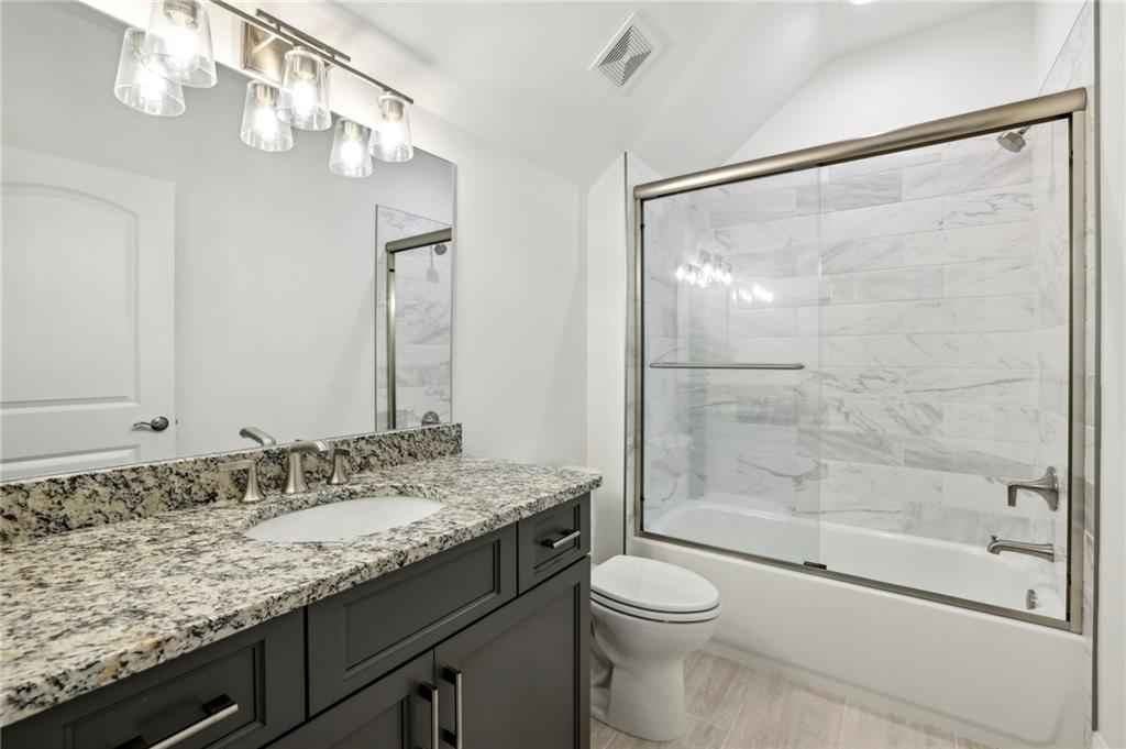 3750 Robinson Road Northeast Marietta, GA 30068 - Photo 45 of 57 a bathroom with a granite countertop sink toilet and shower