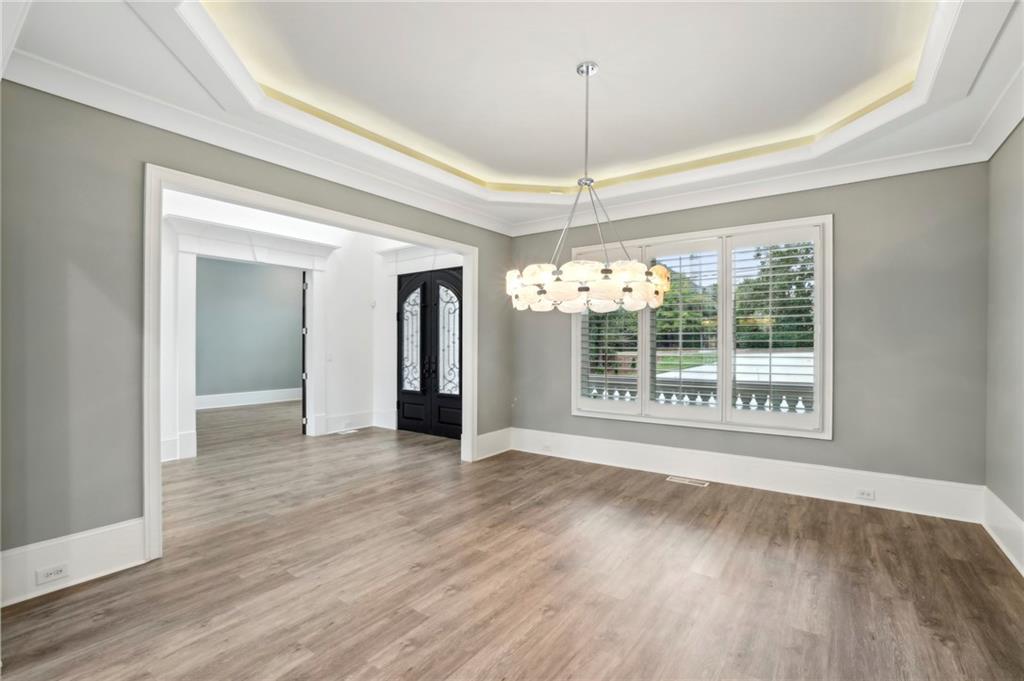 3750 Robinson Road Northeast Marietta, GA 30068 - Photo 6 of 57 a view of an empty room with wooden floor kitchen view and a window