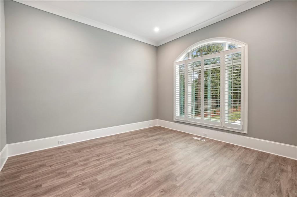 3750 Robinson Road Northeast Marietta, GA 30068 - Photo 10 of 57 an empty room with wooden floor and windows