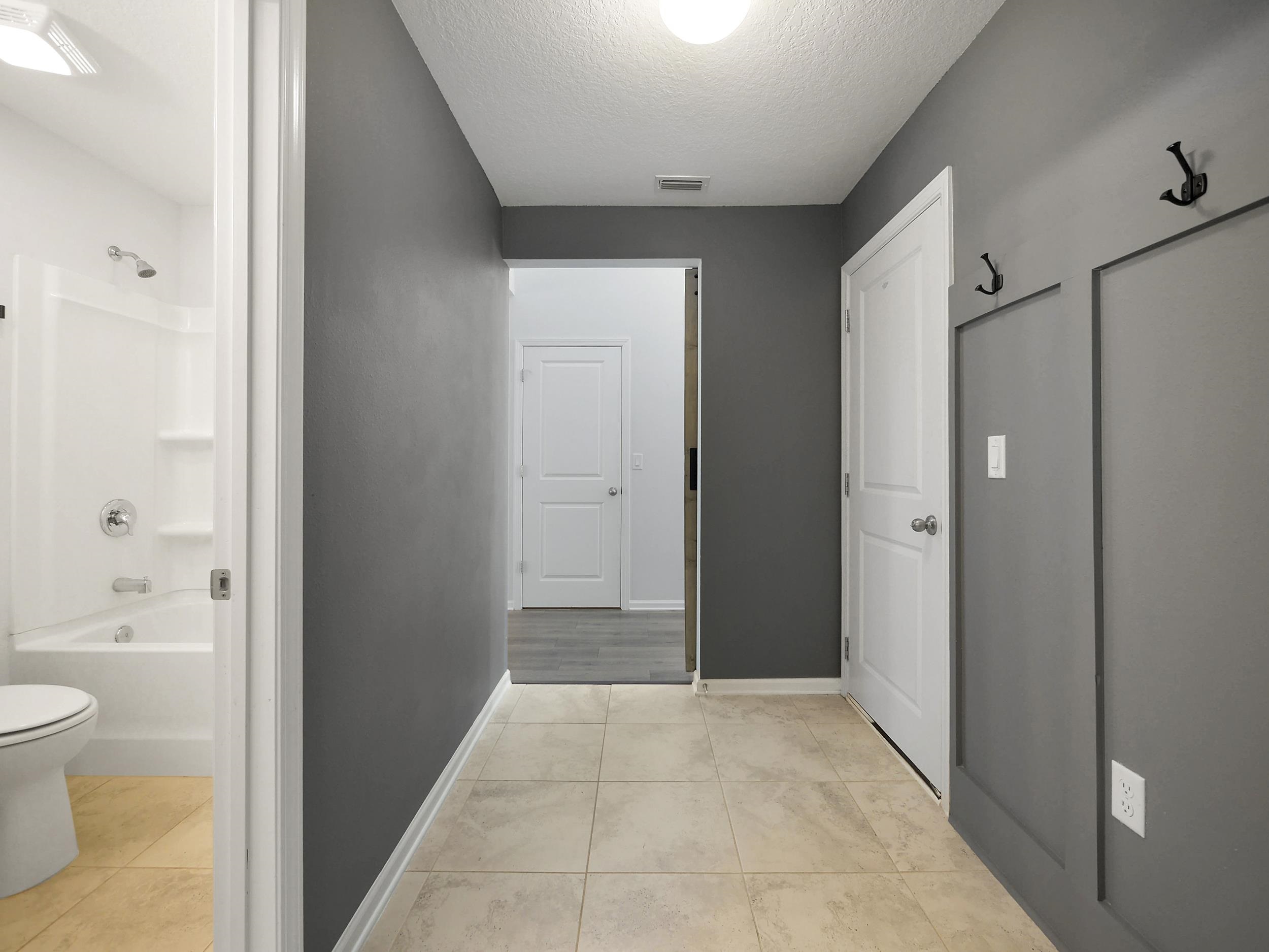 597 Meadow Ridge Drive St. Augustine, FL 32092 - Photo 11 of 56 a bathroom with a granite countertop sink a toilet and shower