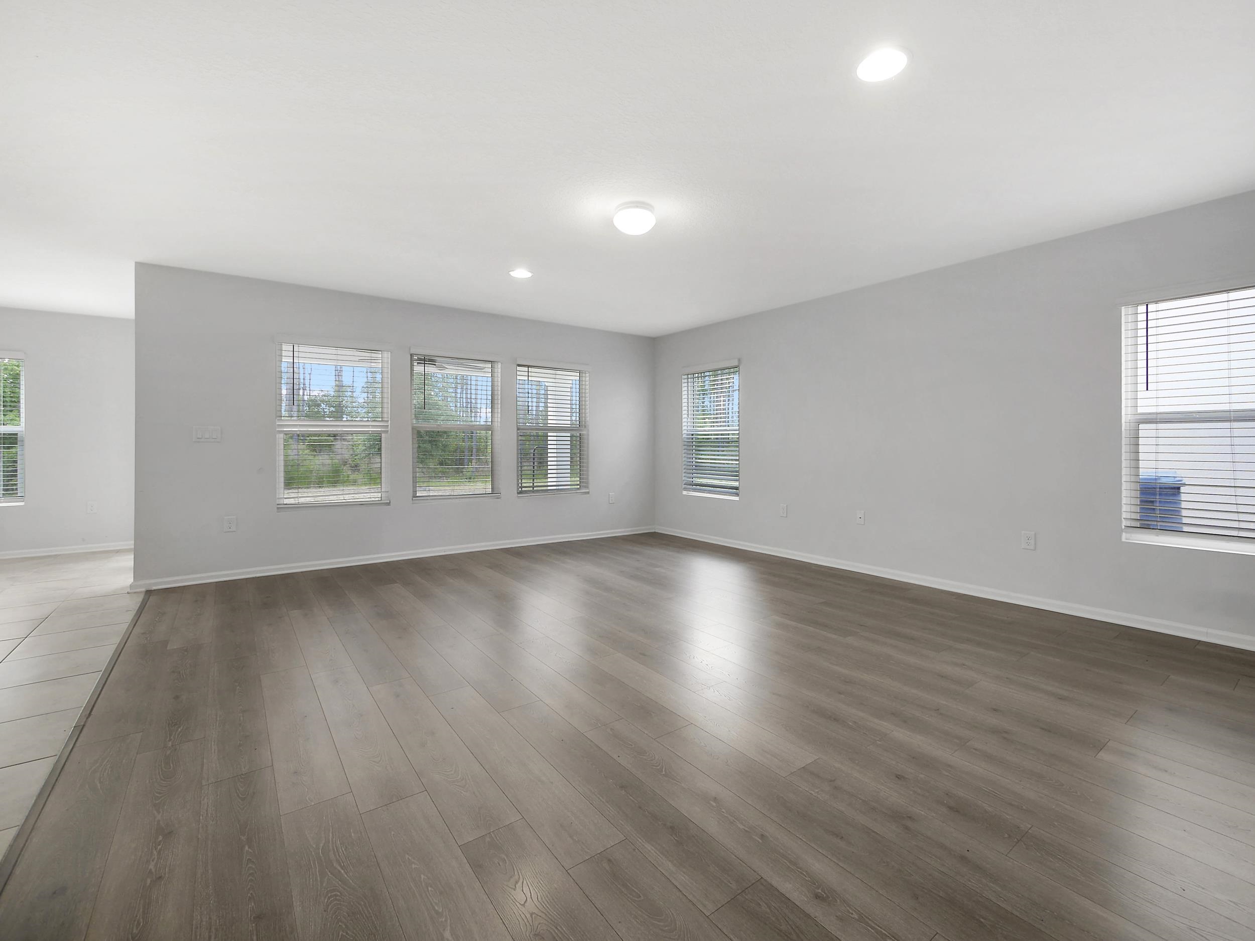 597 Meadow Ridge Drive St. Augustine, FL 32092 - Photo 13 of 56 an empty room with wooden floor and windows