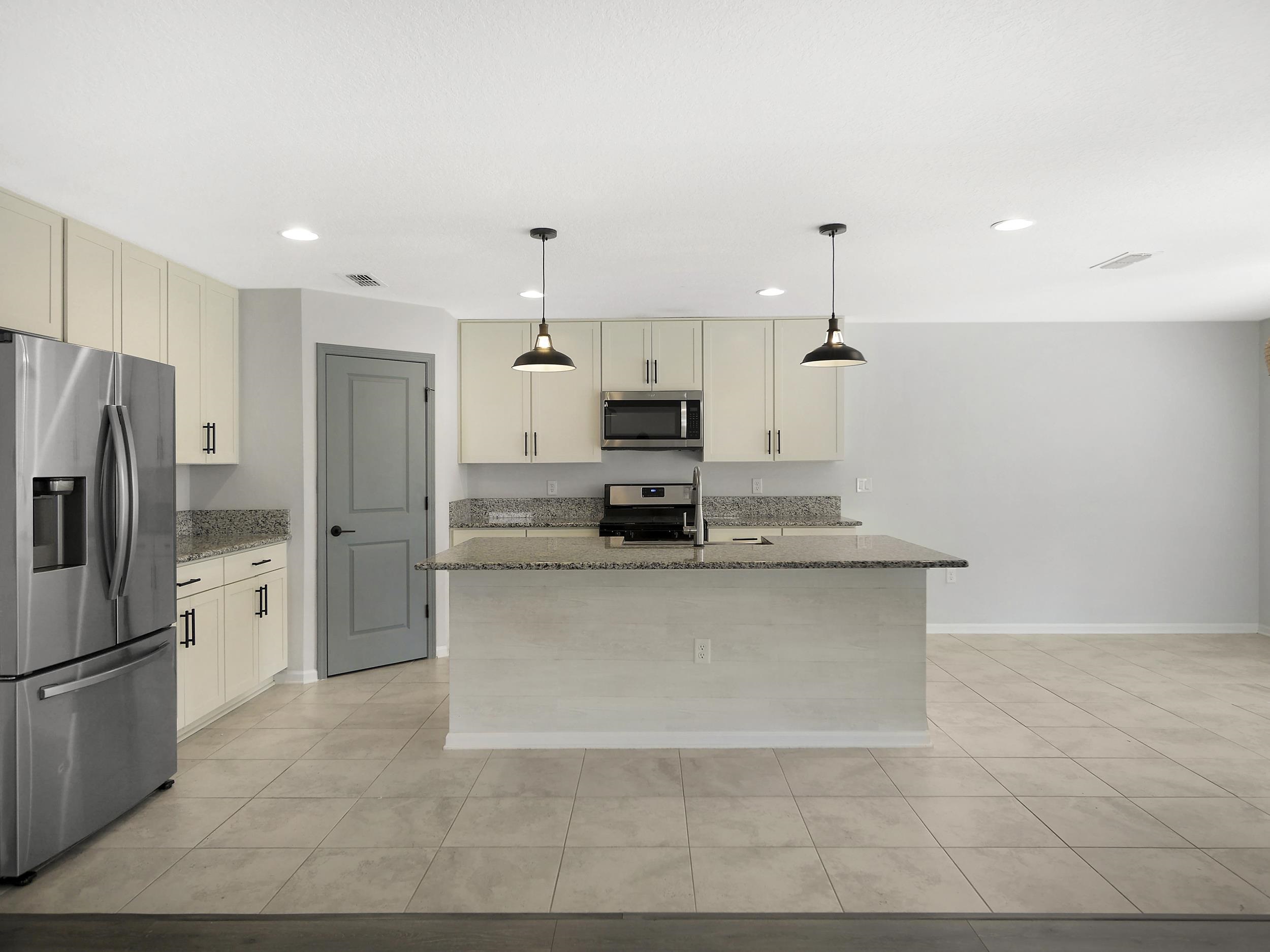 597 Meadow Ridge Drive St. Augustine, FL 32092 - Photo 14 of 56 a large kitchen with cabinets