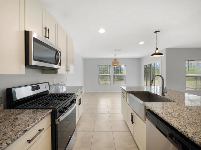 a large white kitchen with cabinets