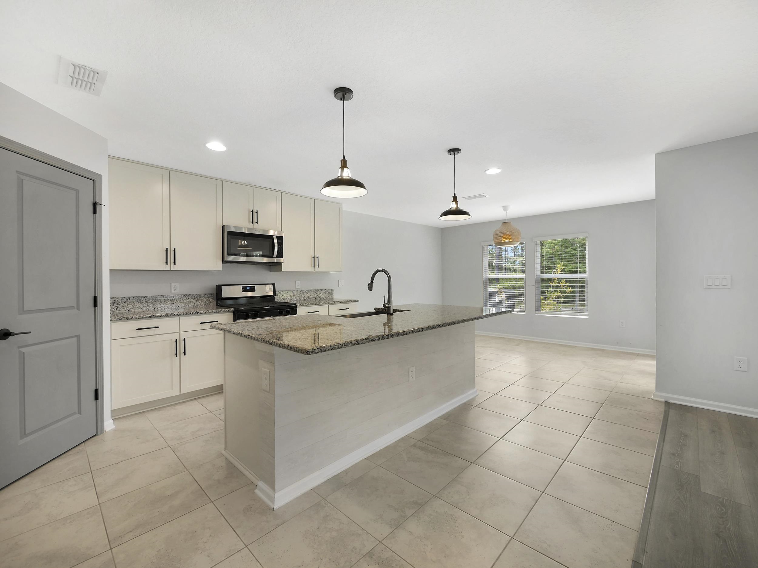 597 Meadow Ridge Drive St. Augustine, FL 32092 - Photo 18 of 56 a large white kitchen with cabinets