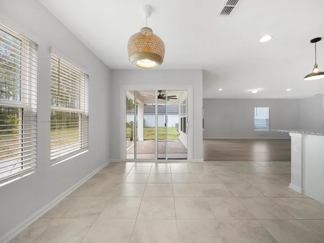 a large kitchen with stainless steel appliances kitchen island granite countertop a large counter top and a stove