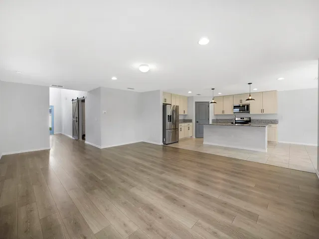 a view of a kitchen with a sink and refrigerator