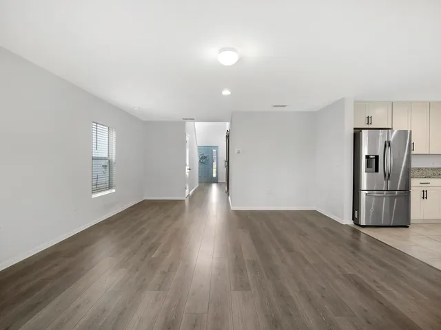 a view of livingroom and dining room with wooden floor