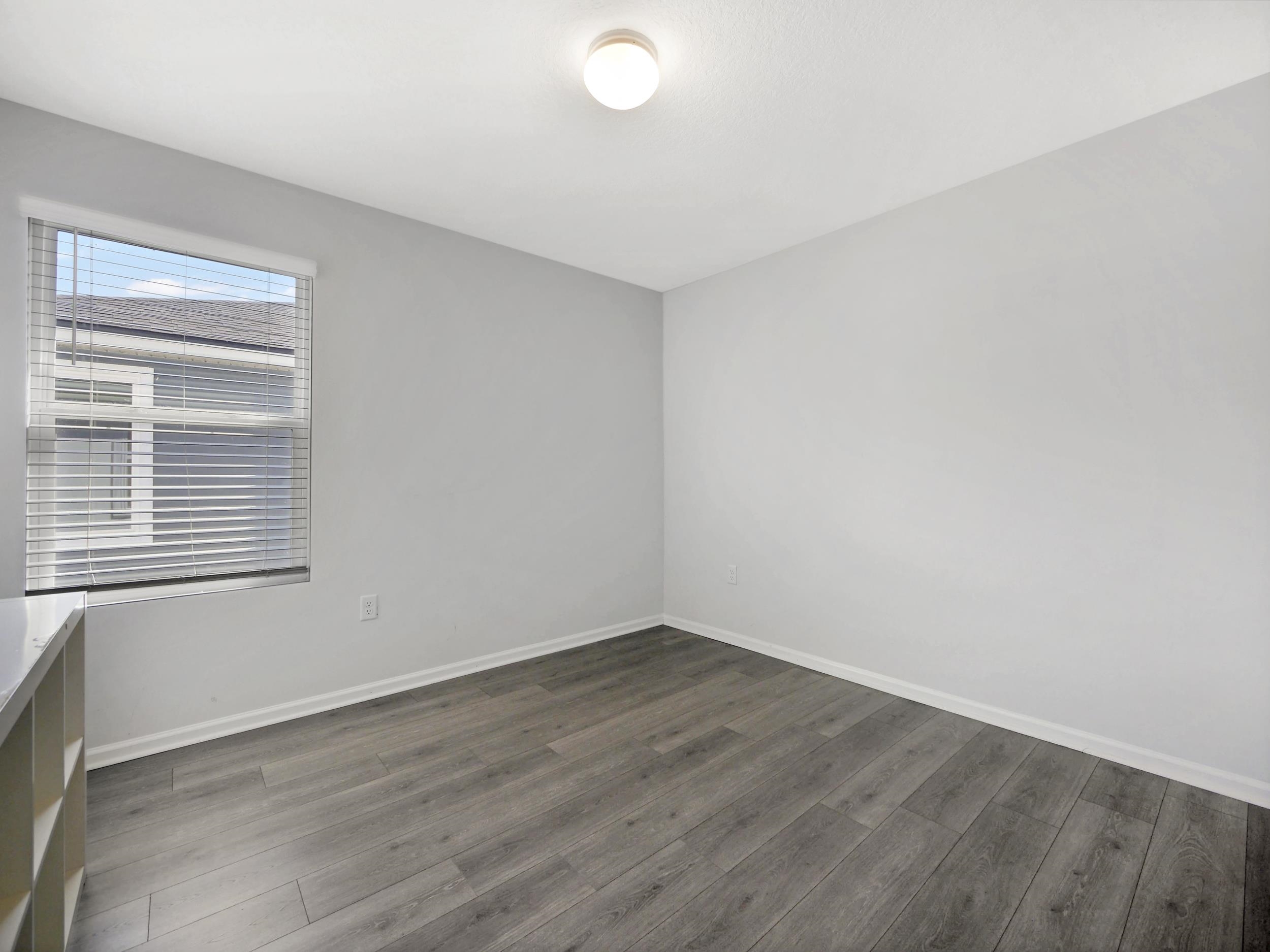 597 Meadow Ridge Drive St. Augustine, FL 32092 - Photo 30 of 56 a view of a room that has wooden floor and windows in it