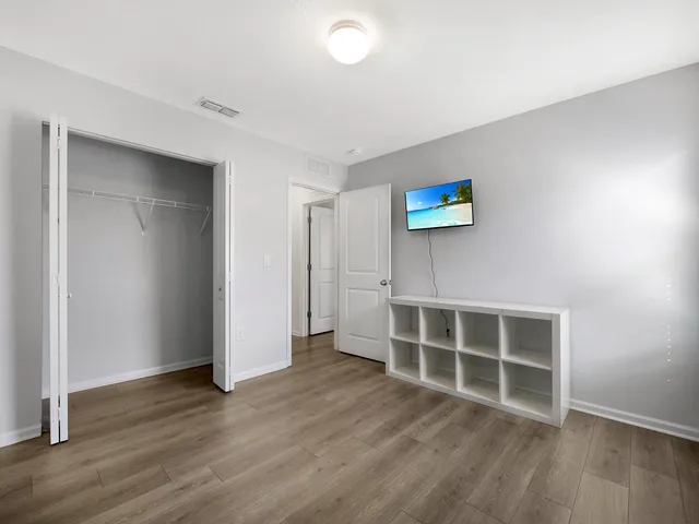 a view of a room with a table and chairs