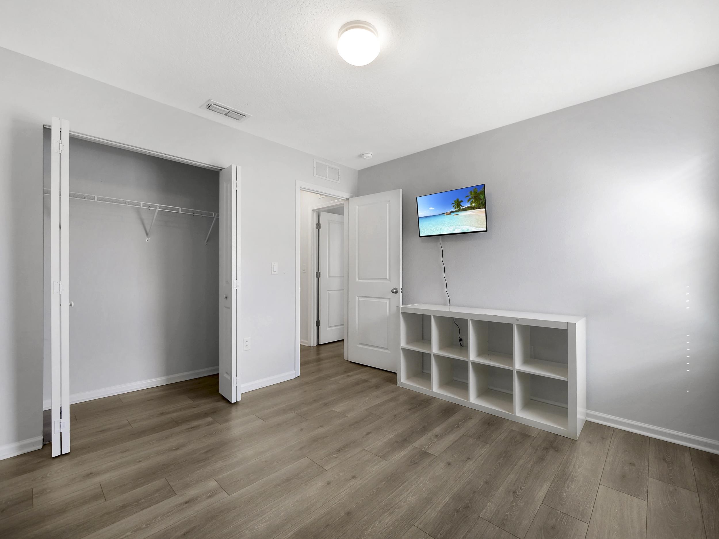 597 Meadow Ridge Drive St. Augustine, FL 32092 - Photo 31 of 56 an empty room with wooden floor and window