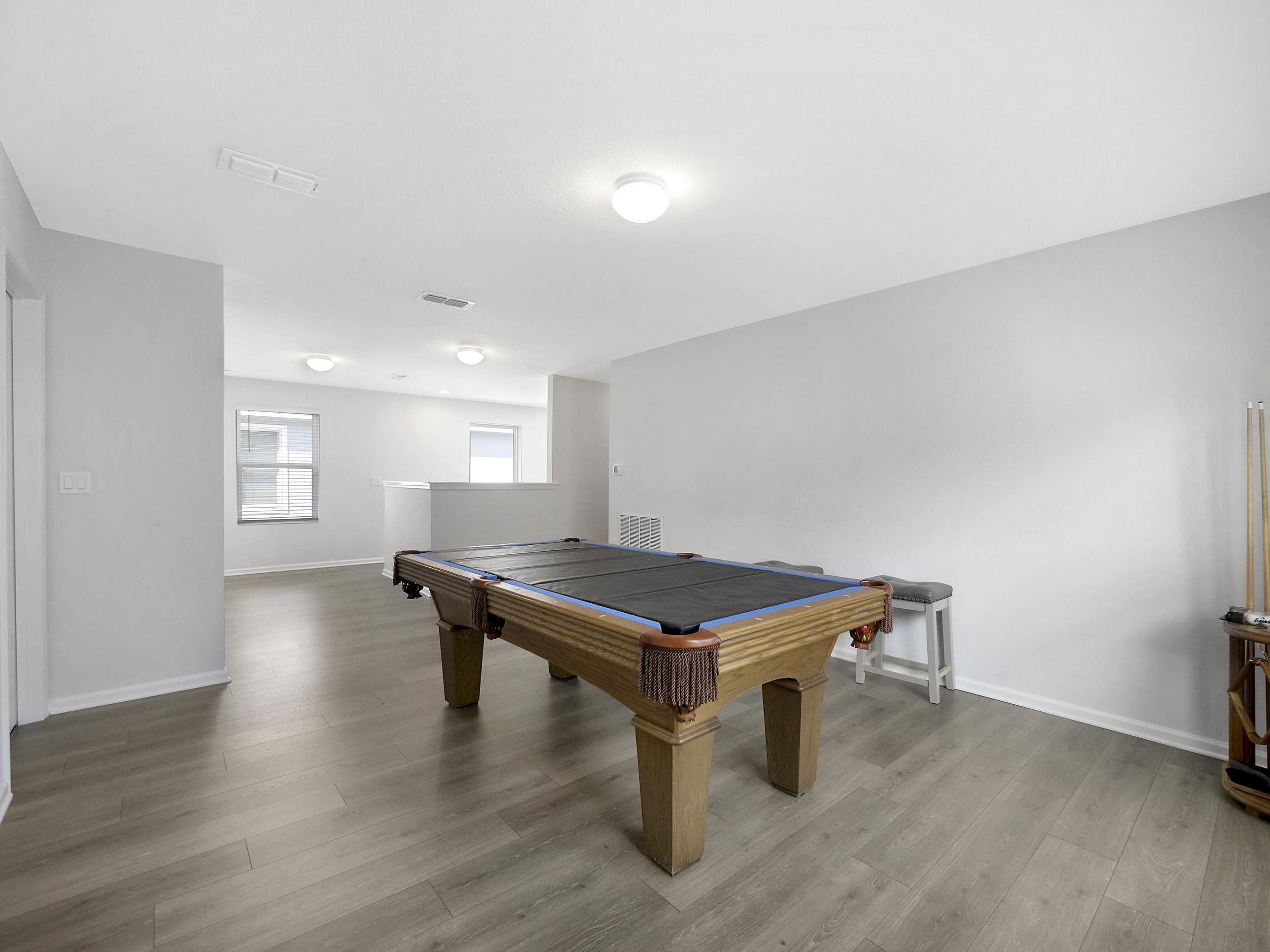 597 Meadow Ridge Drive St. Augustine, FL 32092 - Photo 34 of 56 a room with wooden floor and pool table