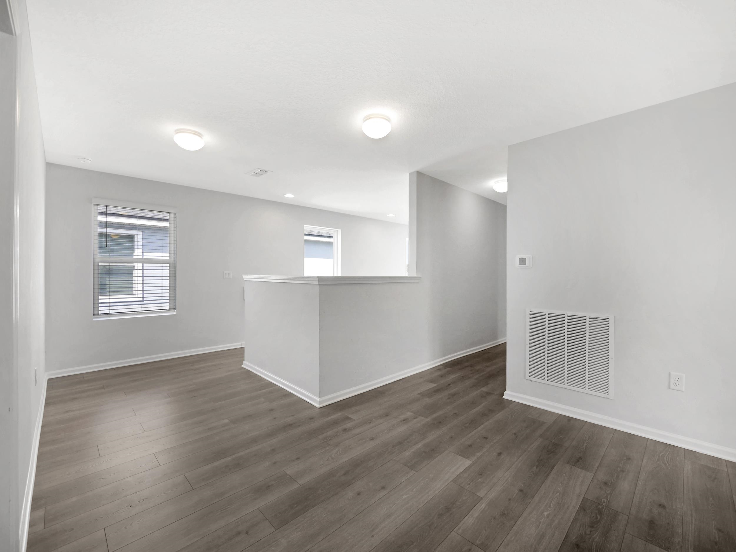 597 Meadow Ridge Drive St. Augustine, FL 32092 - Photo 35 of 56 an empty room with wooden floor and windows