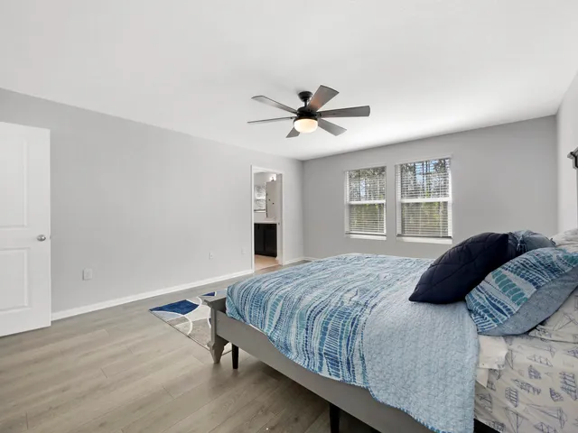 a spacious bathroom with a double vanity sink a mirror and a shower