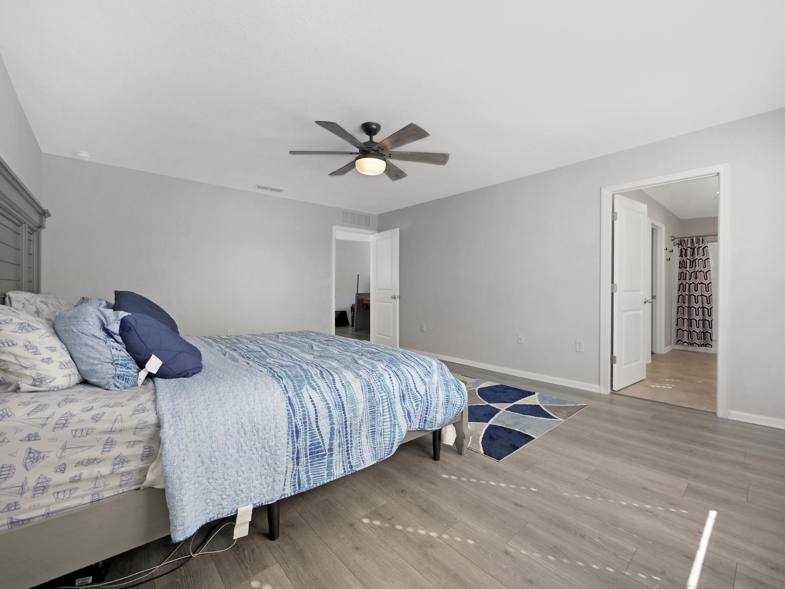 597 Meadow Ridge Drive St. Augustine, FL 32092 - Photo 39 of 56 a bedroom with a bed and a ceiling fan