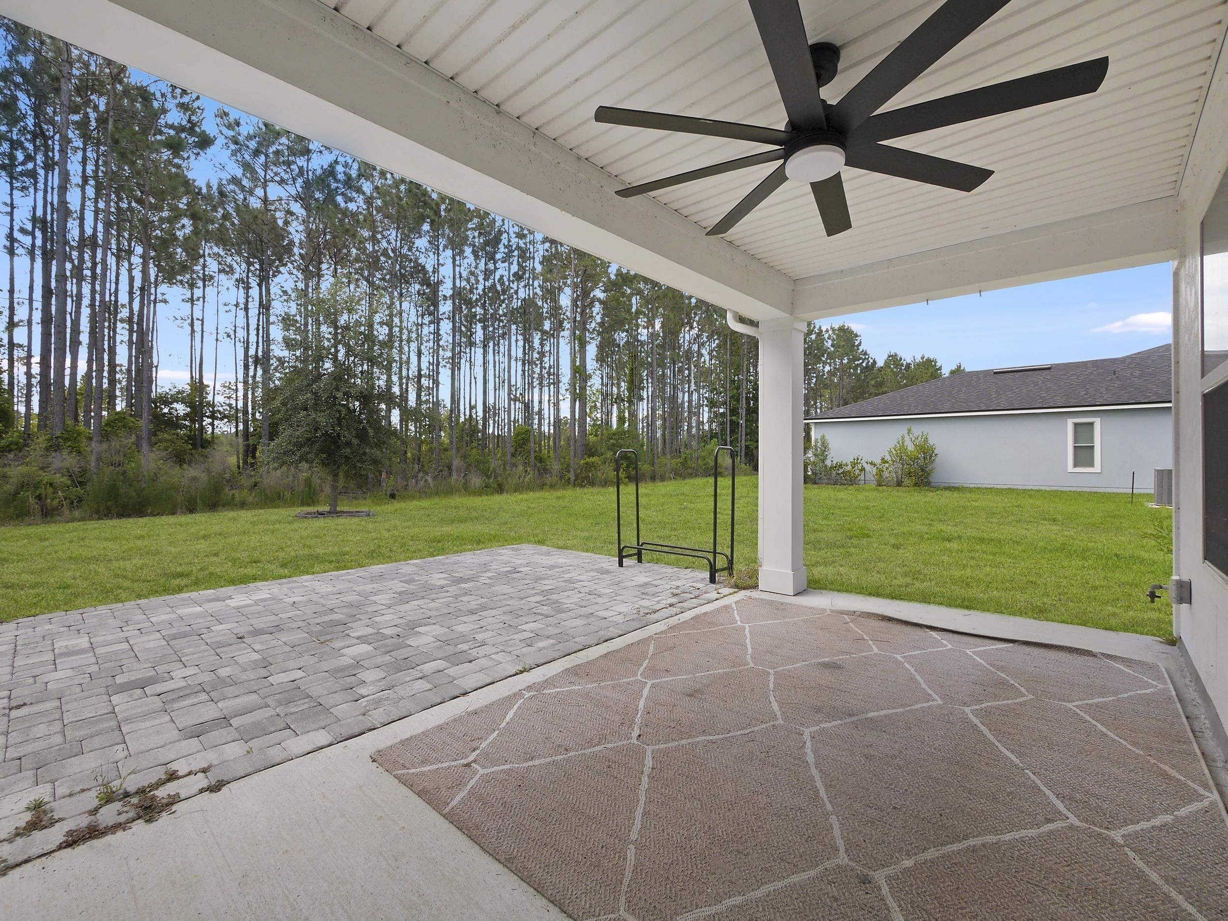 597 Meadow Ridge Drive St. Augustine, FL 32092 - Photo 43 of 56 a view of a house with a big yard and potted plants