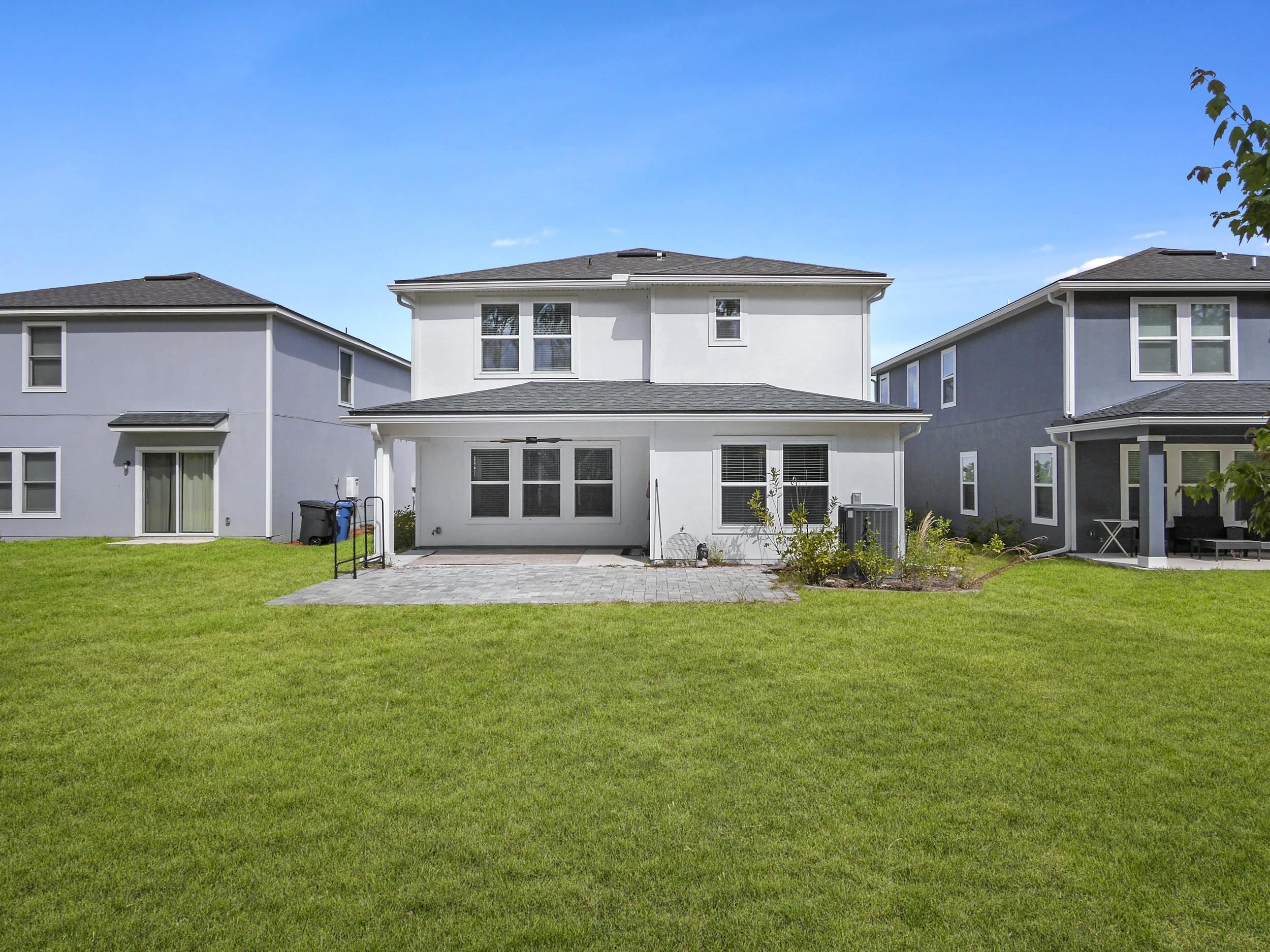 597 Meadow Ridge Drive St. Augustine, FL 32092 - Photo 45 of 56 a front view of a house with a garden