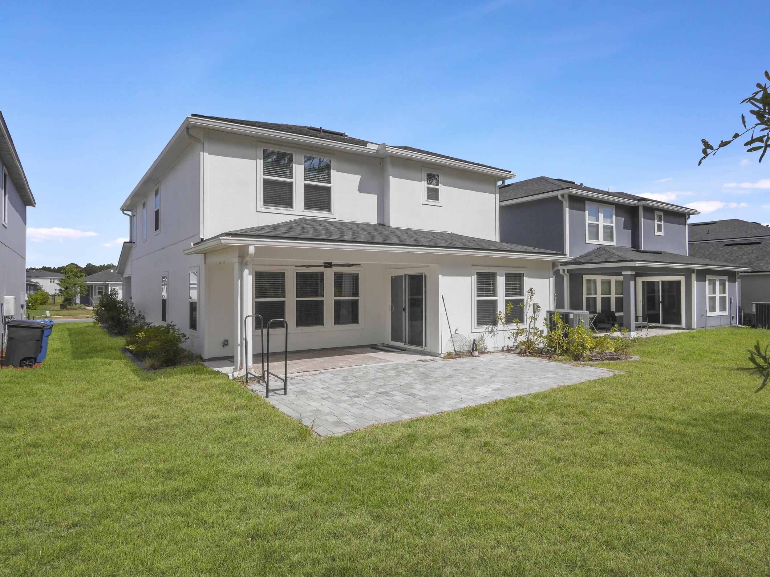 597 Meadow Ridge Drive St. Augustine, FL 32092 - Photo 47 of 56 a front view of a house with a garden