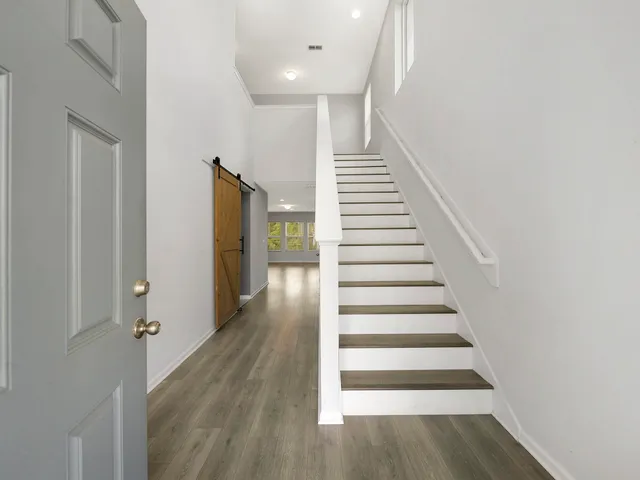 a view of hallway with wooden floor
