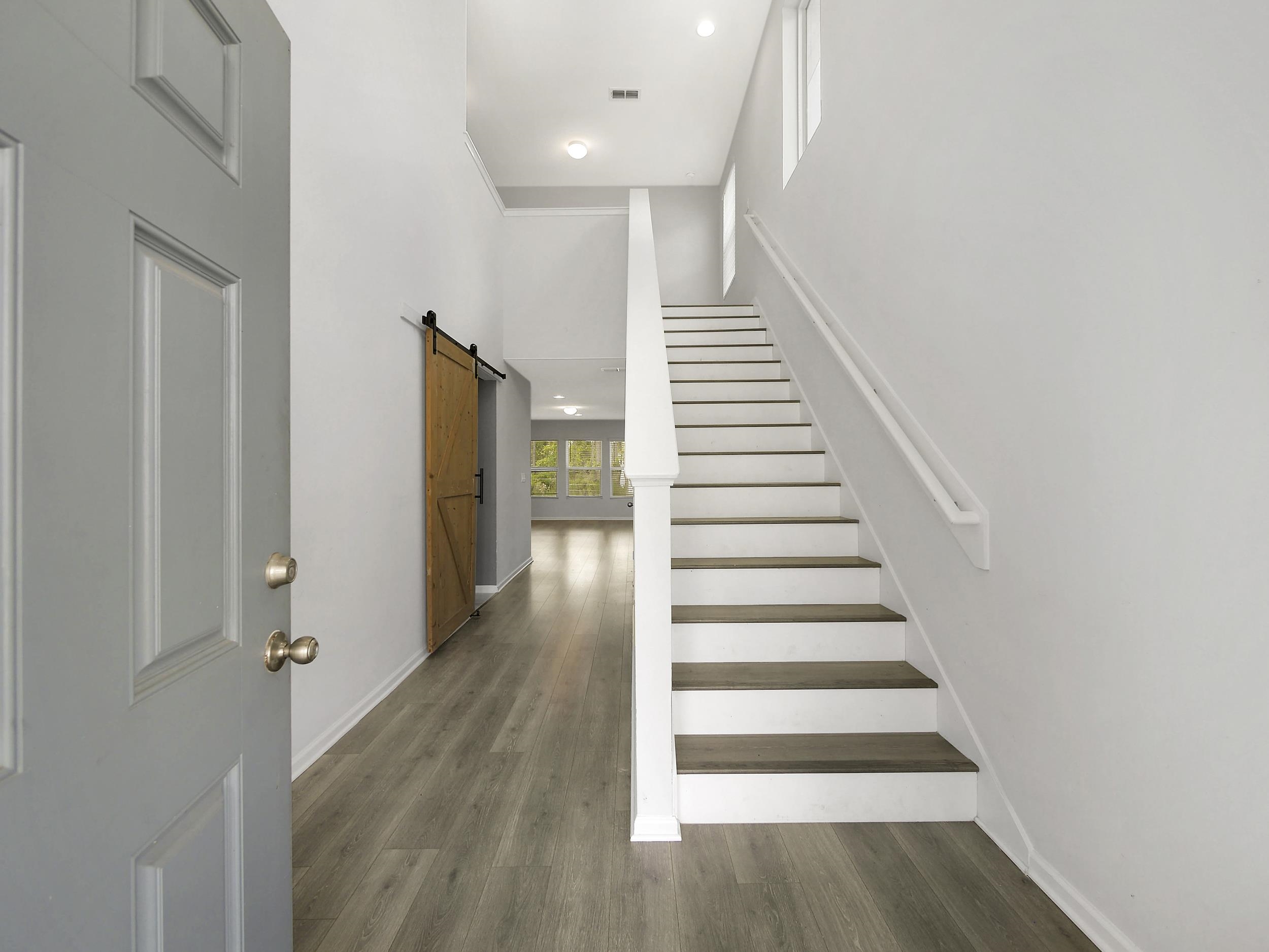 597 Meadow Ridge Drive St. Augustine, FL 32092 - Photo 5 of 56 a view of a hallway with wooden floor and entryway