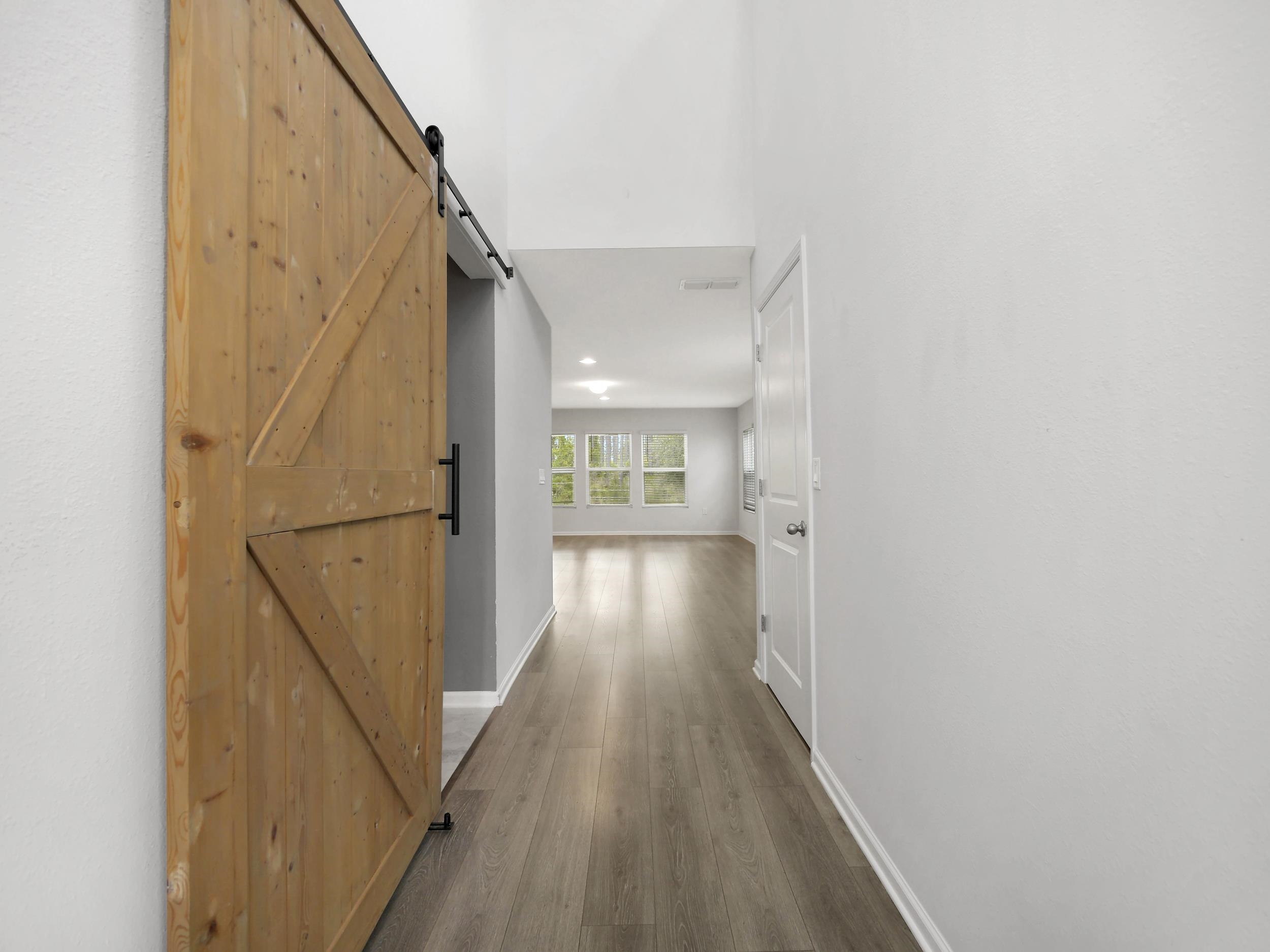 597 Meadow Ridge Drive St. Augustine, FL 32092 - Photo 6 of 56 a view of hallway with wooden floor