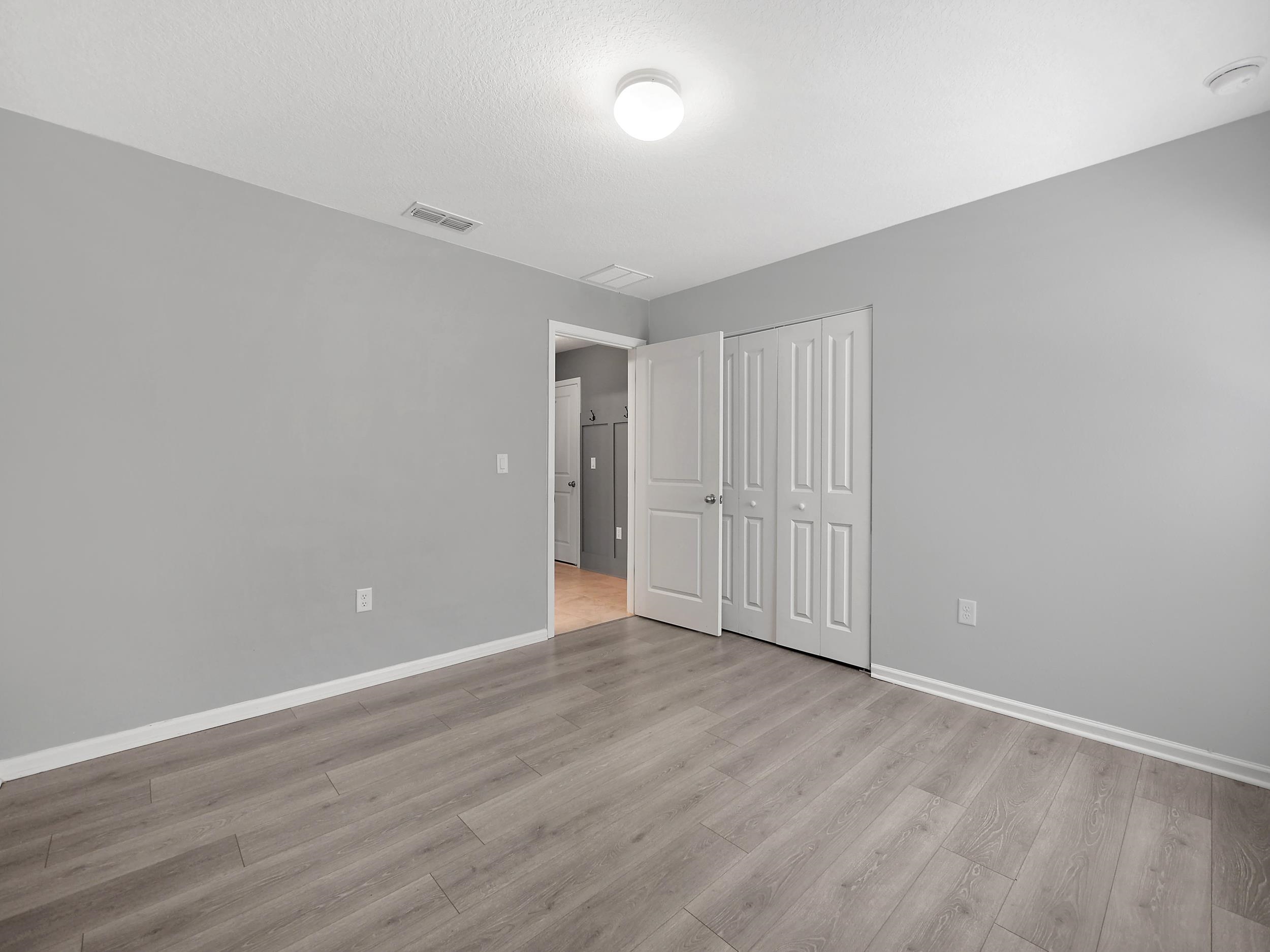 597 Meadow Ridge Drive St. Augustine, FL 32092 - Photo 9 of 56 a view of an empty room with wooden floor