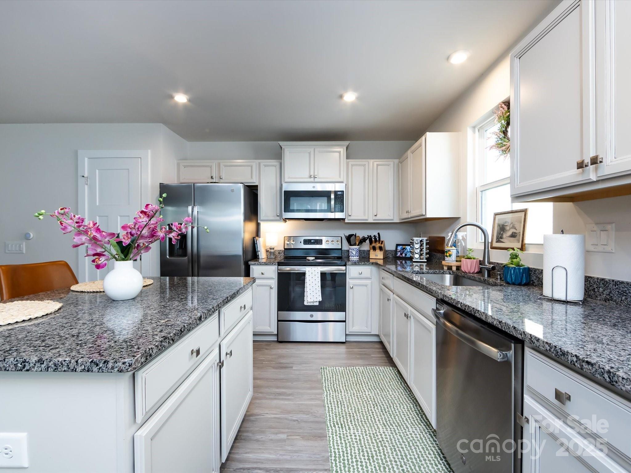 4231 Mackinnon Drive Charlotte, NC 28214 - Photo 15 of 35 a kitchen with granite countertop counter top space a sink stainless steel appliances and cabinets