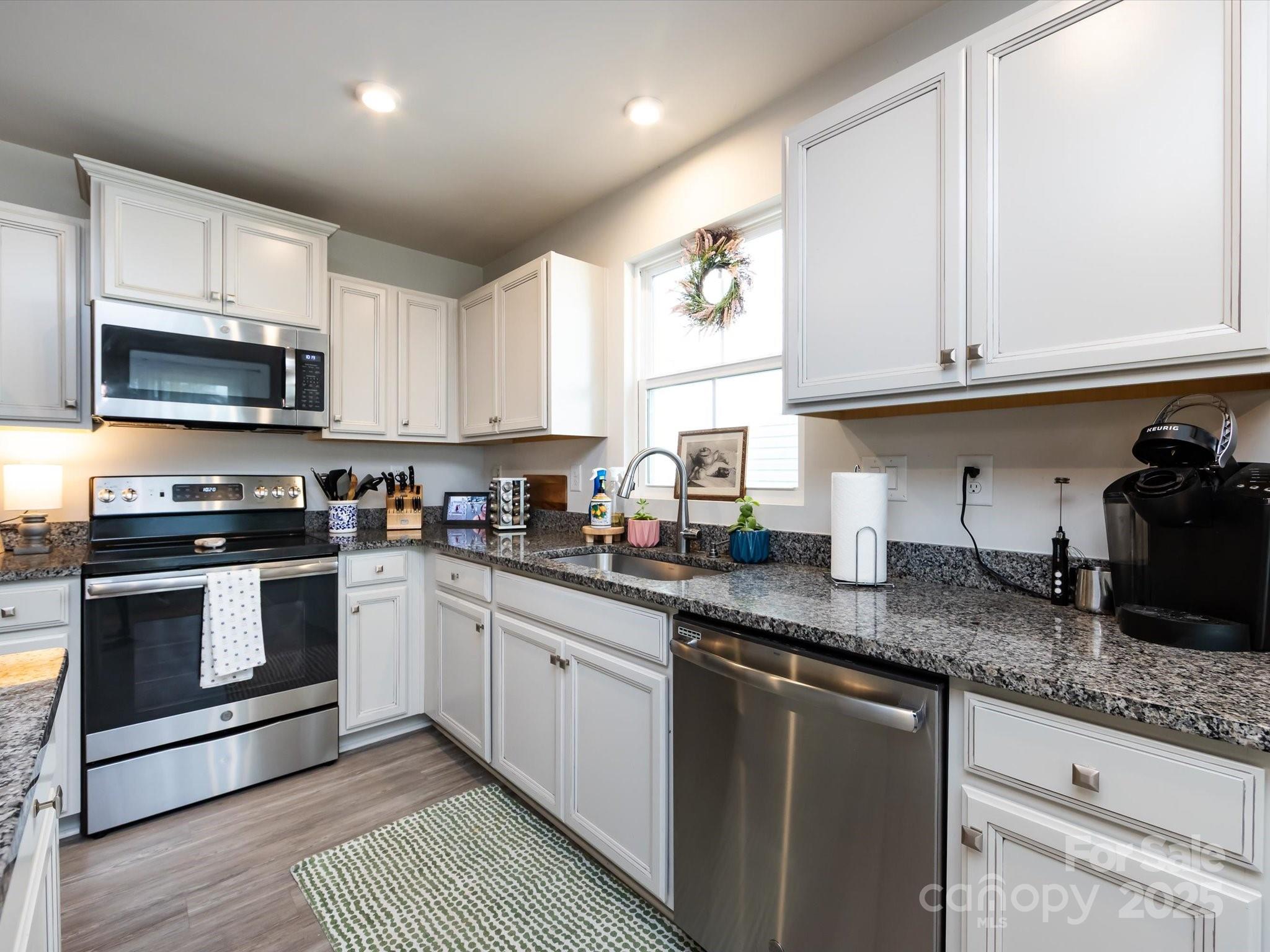 4231 Mackinnon Drive Charlotte, NC 28214 - Photo 16 of 35 a kitchen with granite countertop a sink stainless steel appliances and cabinets